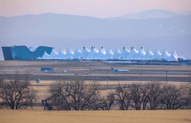 Agricultural landscape with naked spring trees and oil pump in the prairie of Eastern Colorado