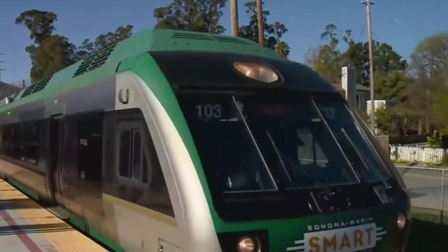 a public transit train arriving at a station 