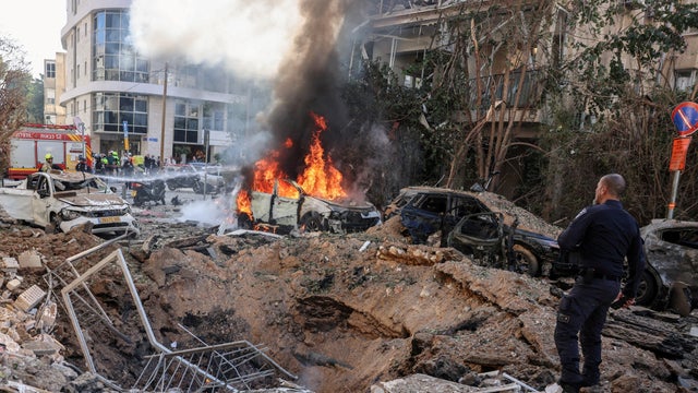 Emergency personnel respond following Iranian missile barrages in central Israel, amid the U.S.-Israel conflict with Iran, in Tel Aviv, Israel, March 24, 2026. 