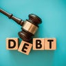 Gavel and wood block with DEBT 