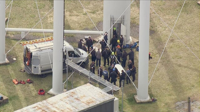 First responders at the base of the water tower as the rescue unfolds 