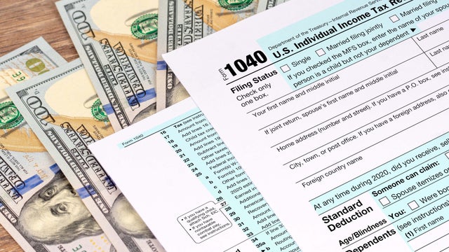 tax return application form with dollar banknotes 