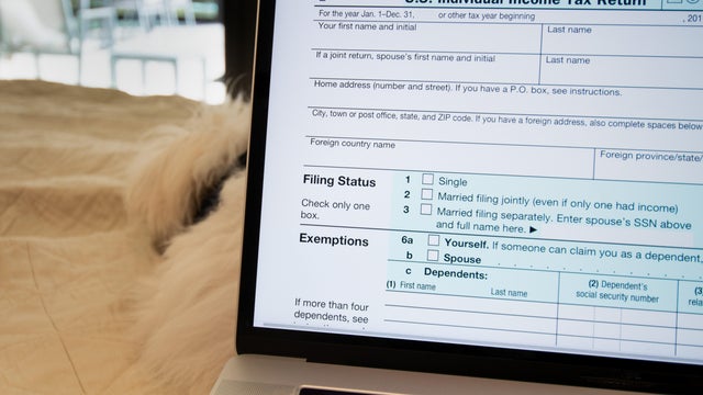 Woman preparing tax documents and declaration at home office 