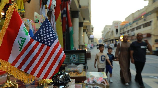 U.S. and Iraqi flags are pictured on a street in Baghdad on June 12, 2025. 