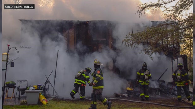 firefighters outside smoking house 