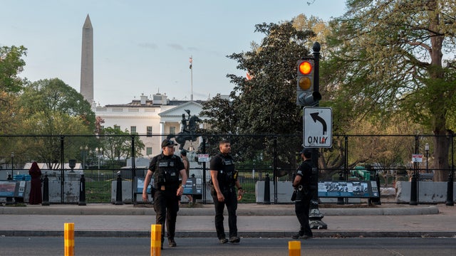 Secret Service Uniformed Division officers conduct an evidence sweep near the White House following a report of gunshots on April 5, 2026 in Washington, D.C. 