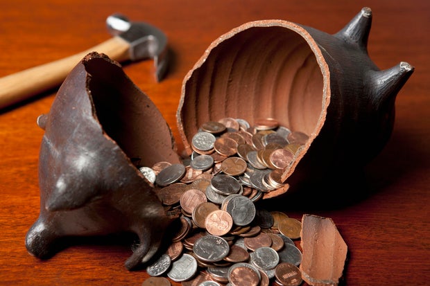 Piggy bank broken open by hammer 
