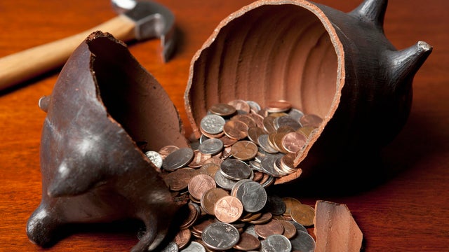 Piggy bank broken open by hammer 