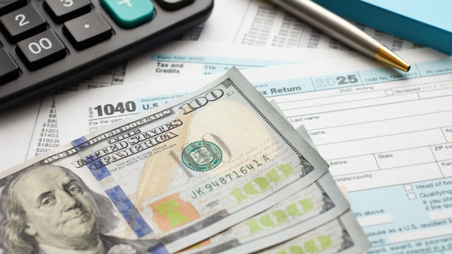 US Currency with calculator and Tax Form 