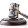 Justice and money. Judge gavel with roll of dollar banknotes on white background. 