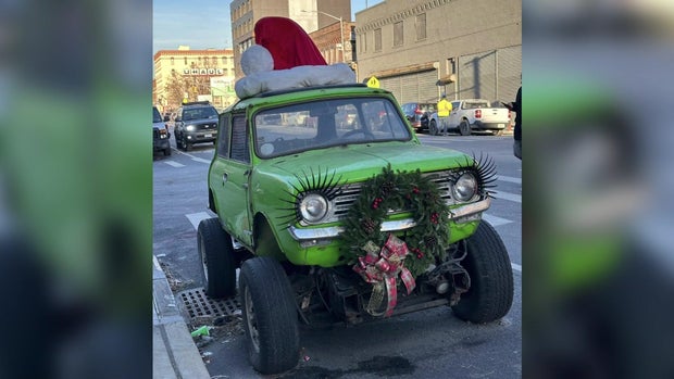 Green mini monster truck with Santa hat and wreath 
