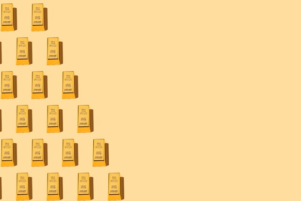 Pattern of 200-gram gold bars of 9.999 fineness, on the left side, on a yellow background. Wealth, reserve, safe haven, inflation, GDP, finance, investment, monetary, rich and economy.