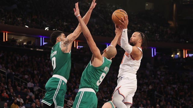 Jalen Brunson #11 of the New York Knicks passes the ball to Josh Hart #3 (not pictured) against Jayson Tatum #0 and Derrick White #9 of the Boston Celtics during the second quarter at Madison Square Garden on April 09, 2026 in New York City. 