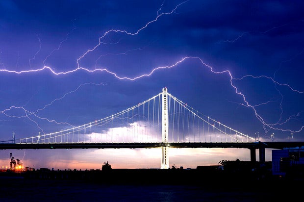 A lightning strike is seen above the San Francisco-Oakland Bay Bridge 