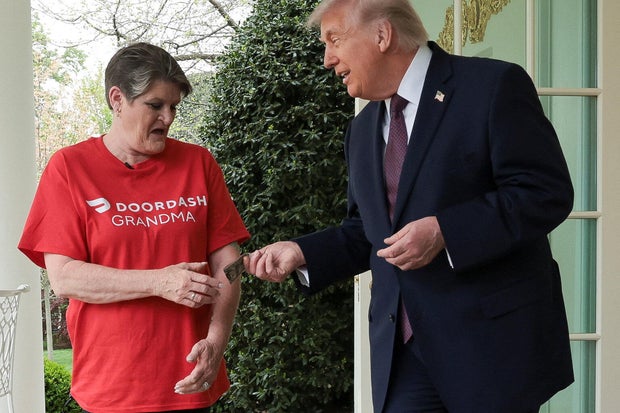 President Trump pays Sharon Simmons after receiving a McDonald's order via DoorDash in front of the Oval Office at the White House, April 13, 2026.