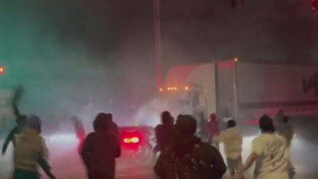 People running toward the scene of a crash at a sideshow 