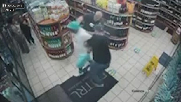 Timothy Brown being arrested in a liquor store by two NYPD officers 