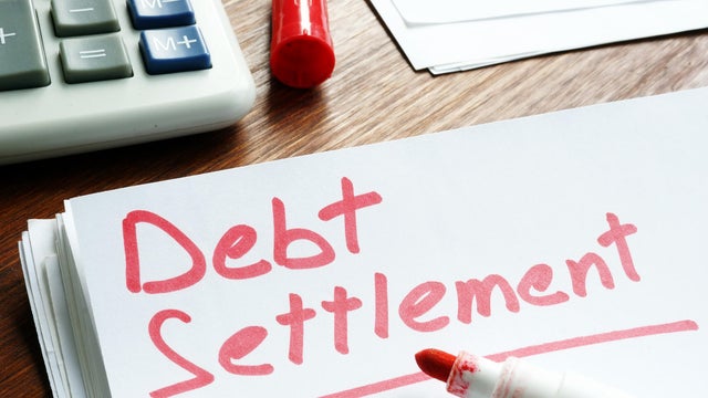 Debt Settlement handwritten on loan documents. 