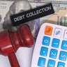 Debt collection concept with gavel, calculator and money 