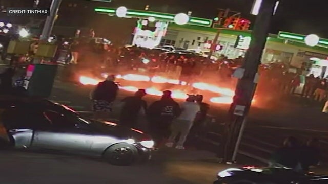 A ring of fire in the middle of an intersection with pedestrians and drivers 