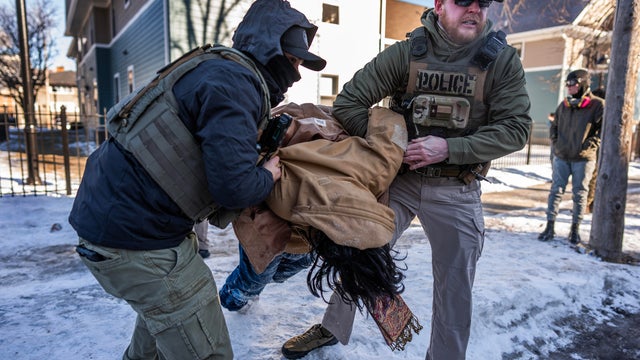 Federal immigration agents and protester, Minneapolis, January 2026 
