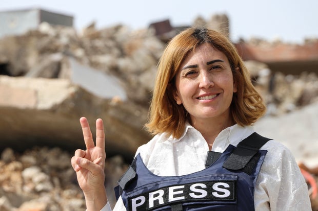 Amal Khalil, a veteran correspondent for the daily newspaper Al-Akhbar, is seen in the southern Lebanese border village of Jebbayn in 2024. 
