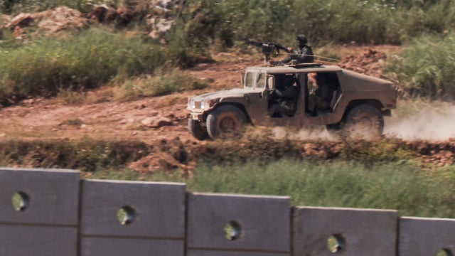 An Israeli armoured vehicle drives inside Lebanon, as seen from the Israeli side of the border with Lebanon 