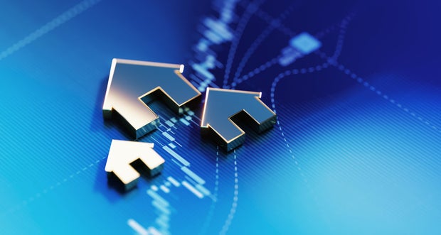 Investment Concept - House Symbols On Blue Financial Graph Background 