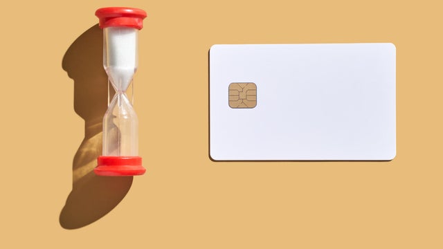 Time management concept with hourglass and blank credit card on beige 