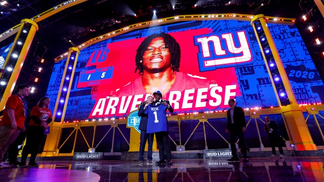 Arvell Reese of Ohio State embraces NFL Commissioner Roger Goodell after being selected fifth overall by the New York Giants during Round One of the 2026 NFL Draft at Acrisure Stadium on April 23, 2026 in Pittsburgh, Pennsylvania. 