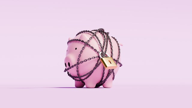 Piggy bank wrapped in a chain with a lock 