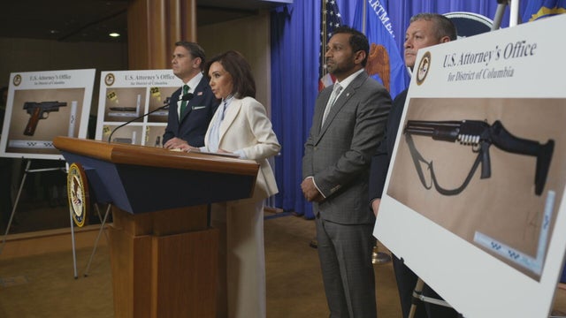 Justice Department officials stand in front of photos of the weapons allegedly carried by Cole Allen, the suspect charged with trying to assassinate President Trump at the White House Correspondents' Dinner. 