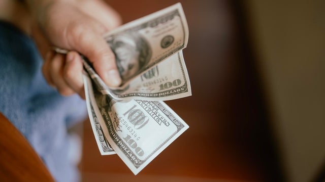 Close up Hand Squeeze  US Dollar Bills 