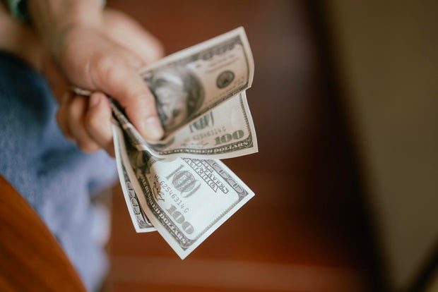 Close up Hand Squeeze  US Dollar Bills 