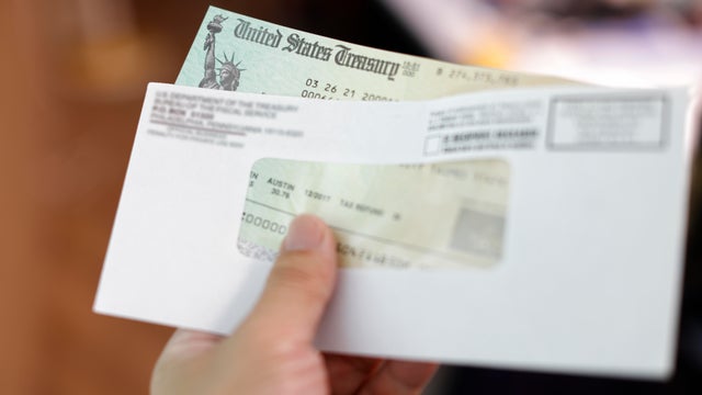 Man holding a tax refund check 