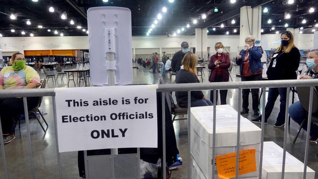 Election officials listen as procedural issues are argued during a ballot recount at the Wisconsin Center in Milwaukee, Wisconsin, on Nov. 20, 2020. 