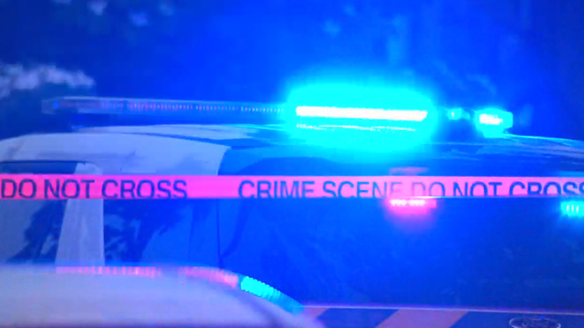 Flashing Lights and Police Tape Reading "Police Line Do Not Cross" 