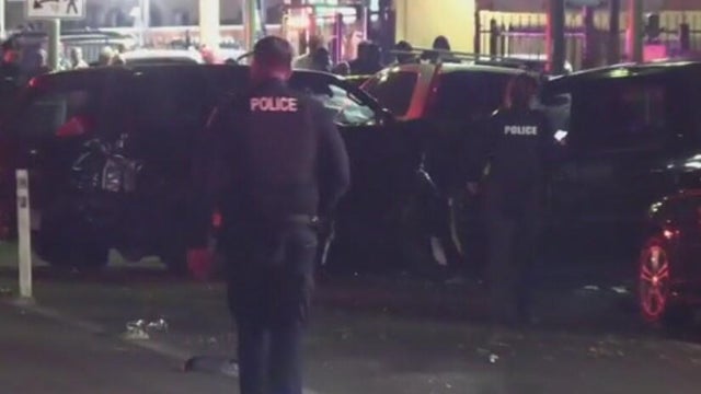 two police officers walking toward the scene of a crash 