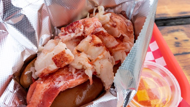 Freshly served delectable and iconic New England style lobster roll with butter 