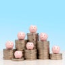 Savings concept - 7 piggy banks on 7 piles of US nickel coins 