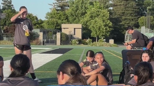 soccer players sitting on the pitch 