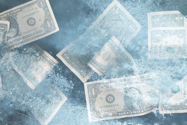 US dollar bills frozen in ice 