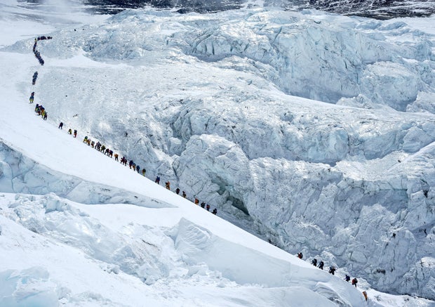 FILE PHOTO: Climbers walk in a long queue as they head to summit Mount Everest in the Solukhumbu district, also known as the Everest region 