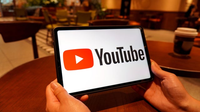 In this photo illustration, the YouTube logo is displayed on 