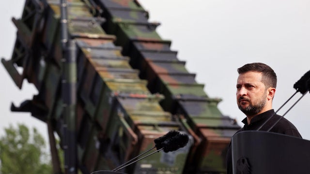 Ukrainian President Volodymyr Zelenskyy stands in front of a Patriot air defense missile system at a military training area in Germany on June 11, 2024. 