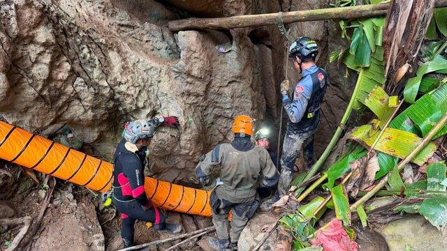 Members of a rescue team work to save seven people trapped in a cave, at a location given as Xaisomboun Province 