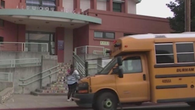 a school bus parked in front of a school 