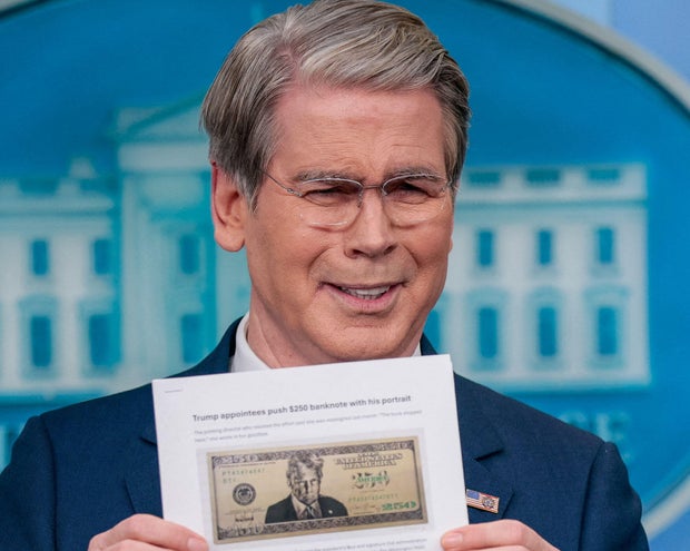 Treasury Secretary Scott Bessent holds up a Washington Post article about a possible $250 bill with the portrait of President Trump during a press briefing at the White House in Washington, D.C., May 28, 2026. 