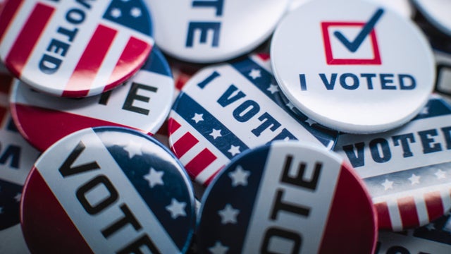 Close up of patriotic badges with American flag logo and inscription Vote 