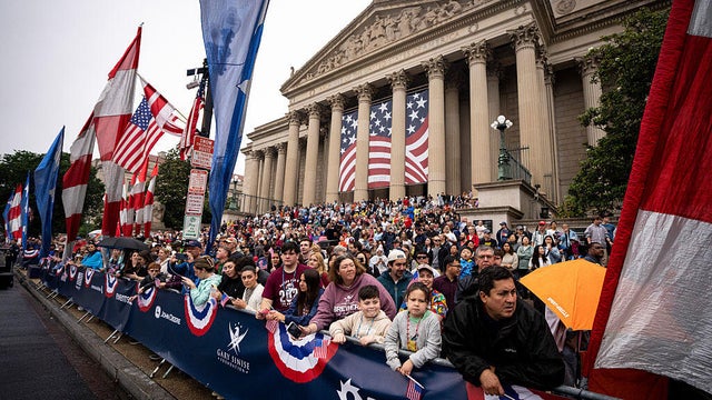 Spectators stand on the steps of the National Archives during the Freedom 250 National Memorial Day Parade in Washington, D.C., on May 25, 2026. 